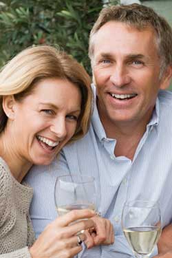 older-couple-smiling-with-wine-glasses-appellation-wine-tasting-tours